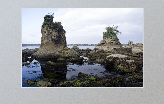 Two large rocks with pool between them